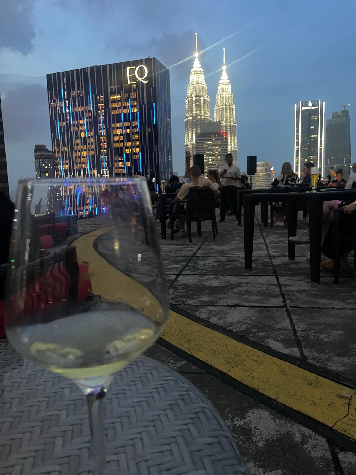 Glass of wine in foreground, Kuala Lumpar city in backdrop